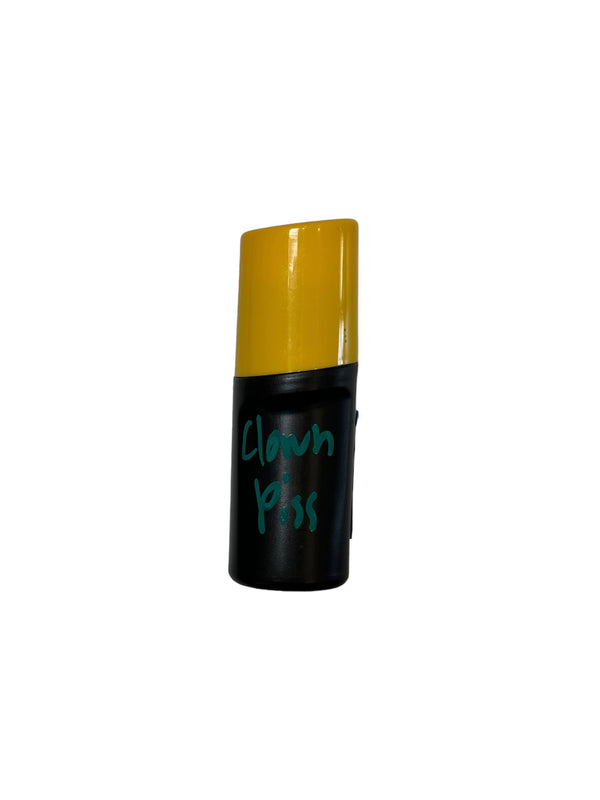 Black plastic bottle with yellow cap of CG Liquid show polish mop in the color Clown Piss
