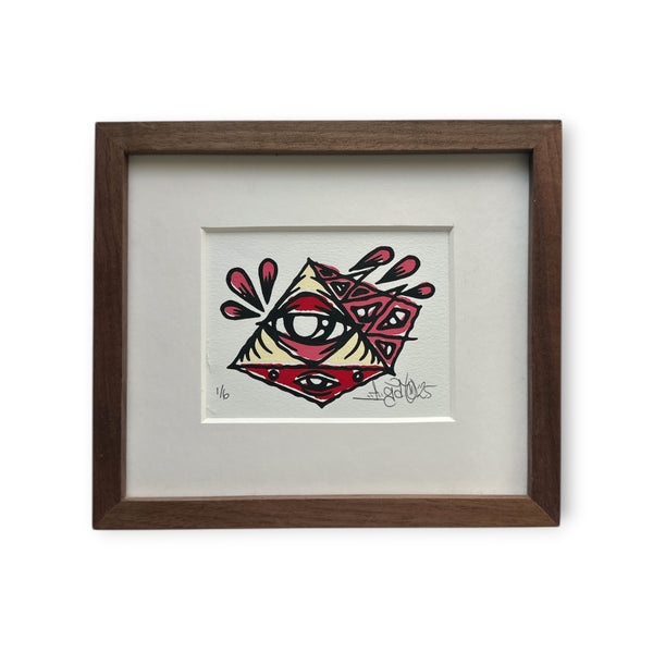 Eye Gato cream and red pyramid painting on white rives paper, mounted on white boards in a brown walnut custom frame.