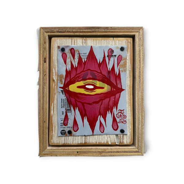 Mixed media Eye Gato red with yellow eye artwork on aluminum, framed with reclaimed street-sign wood.