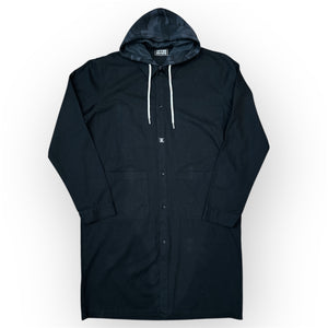 Black long cotton drill coat with black and dark gray camouflage patterned hoodie with white strings.